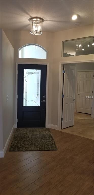 Modern bright entry with wood look tile flooring