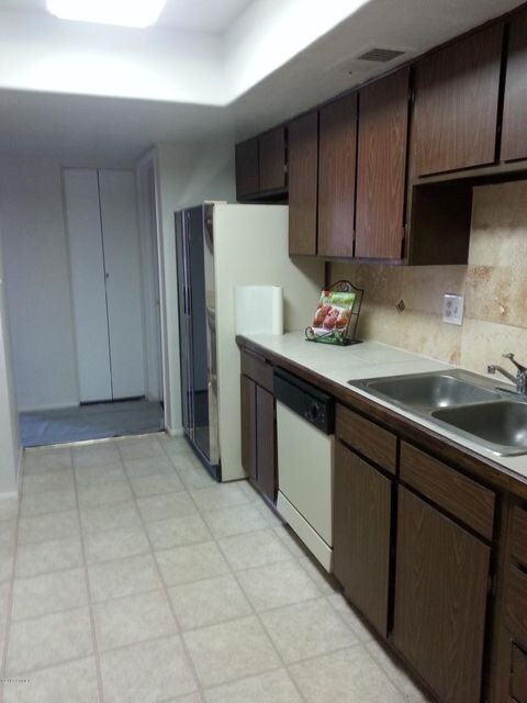 Kitchen With Tile Countertops & Terrazo