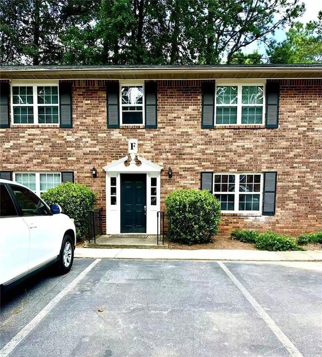View of front of home featuring brick siding and uncovered parking