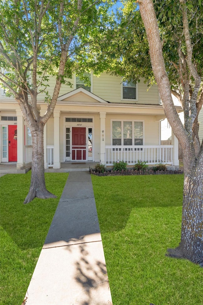 Traditional style home featuring a front yard and a porch