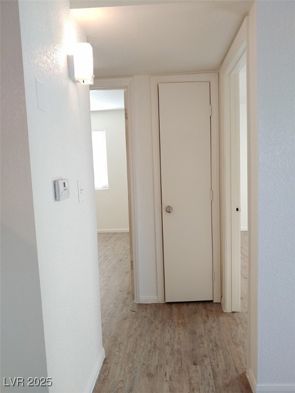 Hallway featuring light hardwood / wood-style floo