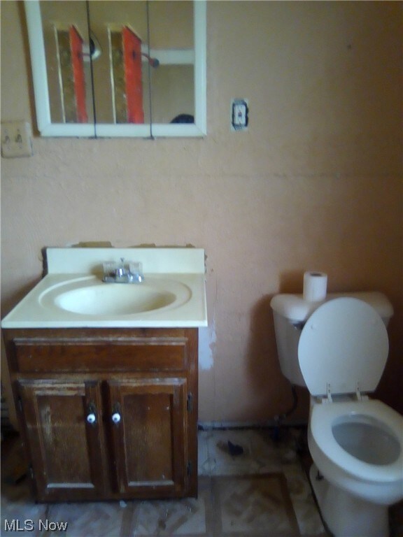 Bathroom featuring vanity and toilet