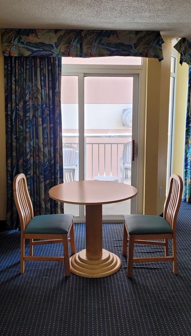 Dining room featuring carpet and a textured ceilin