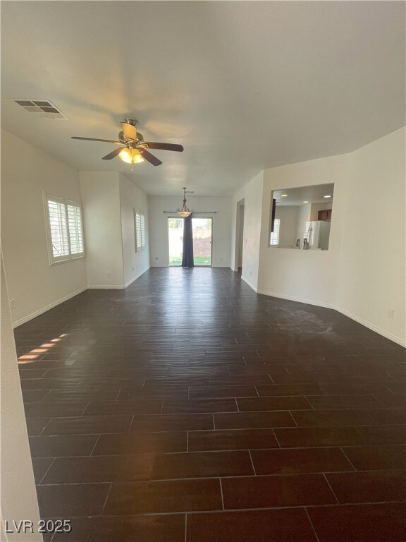 Spare room featuring dark wood-type flooring, visi