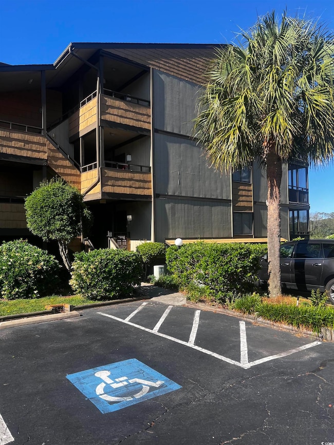 View of property featuring uncovered parking