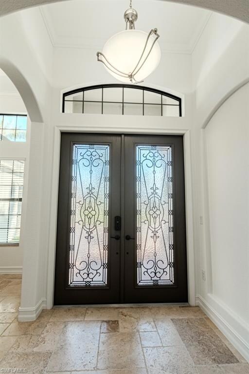 Foyer with french doors and ornamental molding