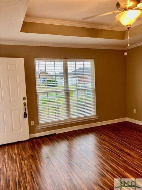 The living room has large double window looking ou