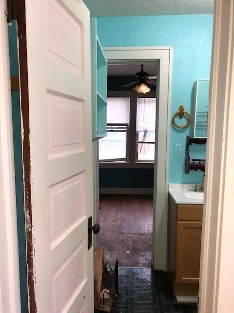 Bathroom featuring ceiling fan, hardwood / wood-st