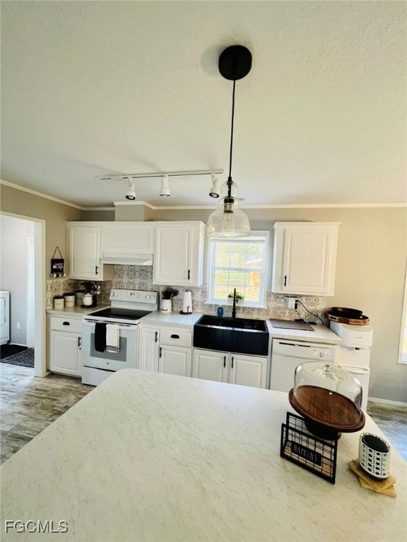 Kitchen with crown molding, white appliances, white cabinetry, tasteful backsplash, and decorative light fixtures