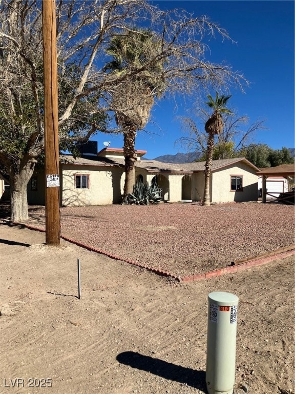 Ranch-style house with stucco siding