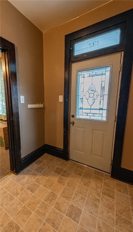 Large entryway with the original wood staircase an