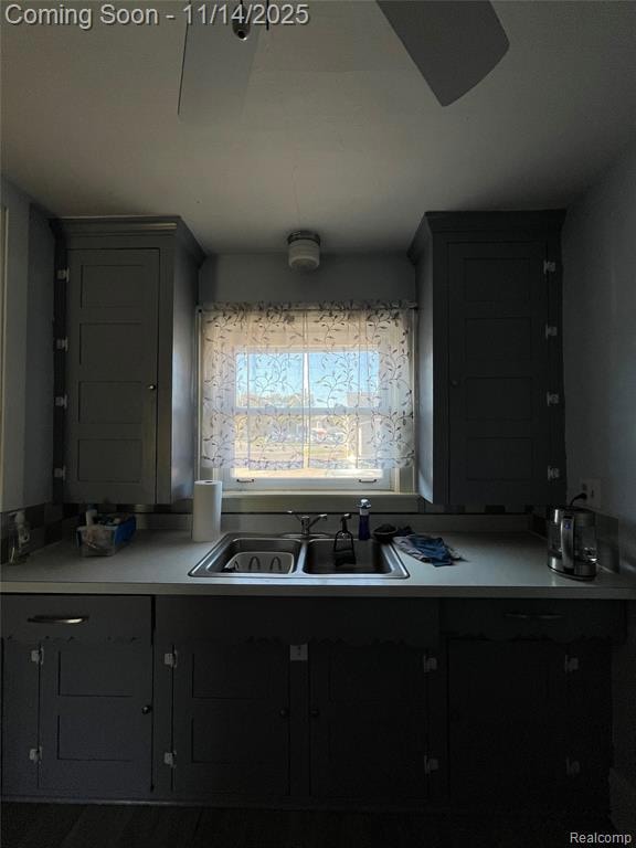 Kitchen featuring light countertops and gray cabinetry