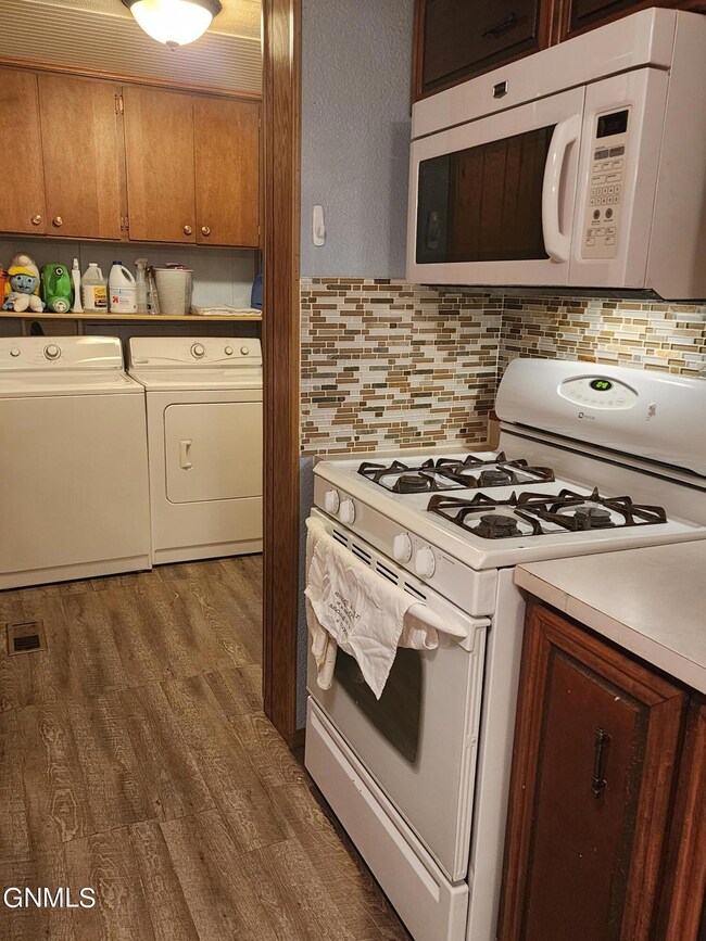 Range, Microwave and view of laundry are