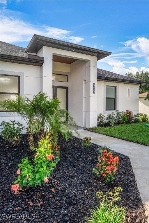 View of exterior entry featuring stucco siding and