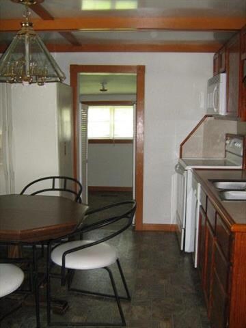 Another kitchen view.  Range, refrigerator, microwave, dishwasher, and trash compactor stay.