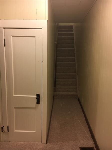Hall closet and stairs to second level