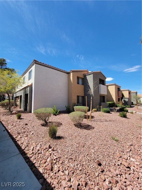 View of side of home with stucco siding