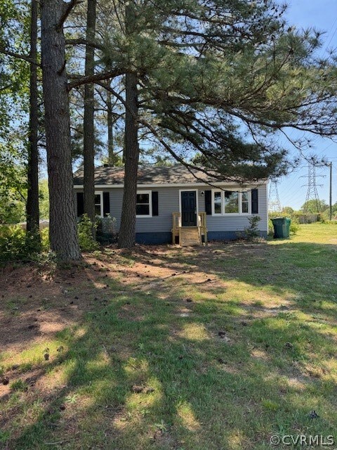Ranch-style home with a front lawn