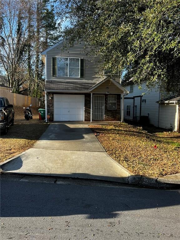 Traditional-style house with driveway, brick sidin