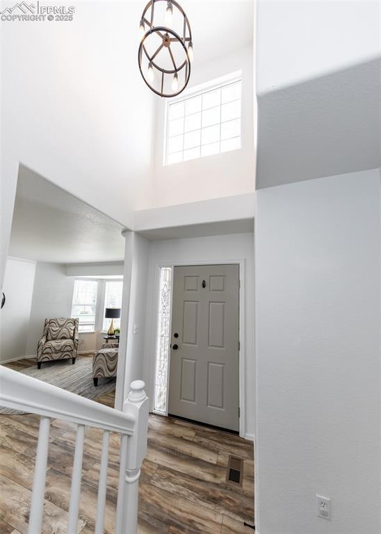 Foyer entrance featuring wood finished floors, a t