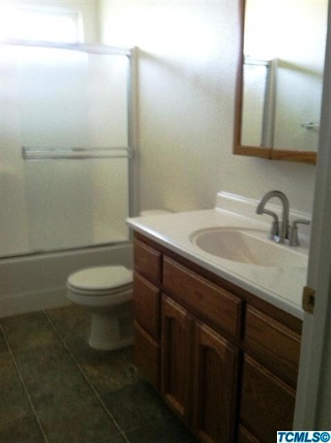 Guest bathroom has higher vanity and oak