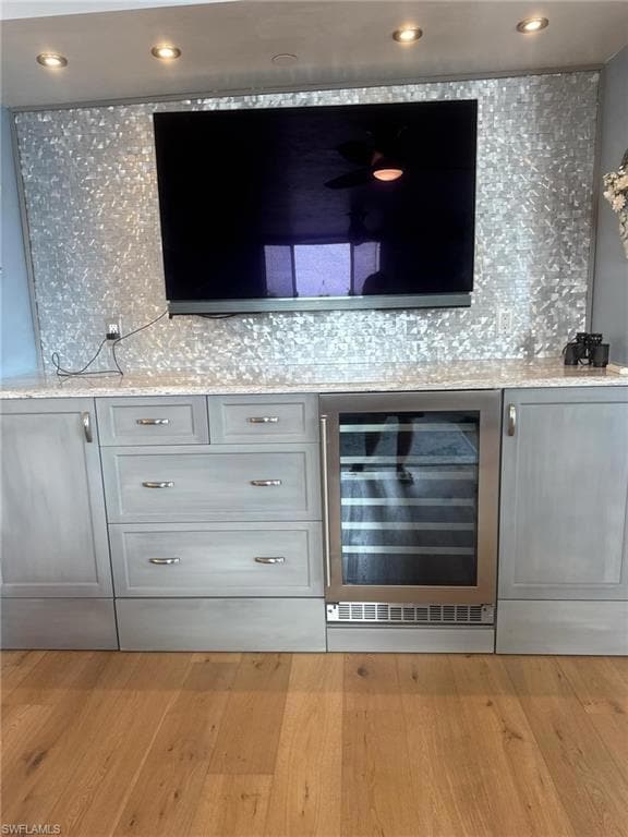 Bar with recessed lighting, light wood-style floor