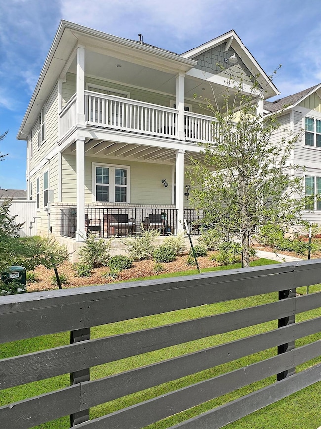 View of front of house with a balcony and covered