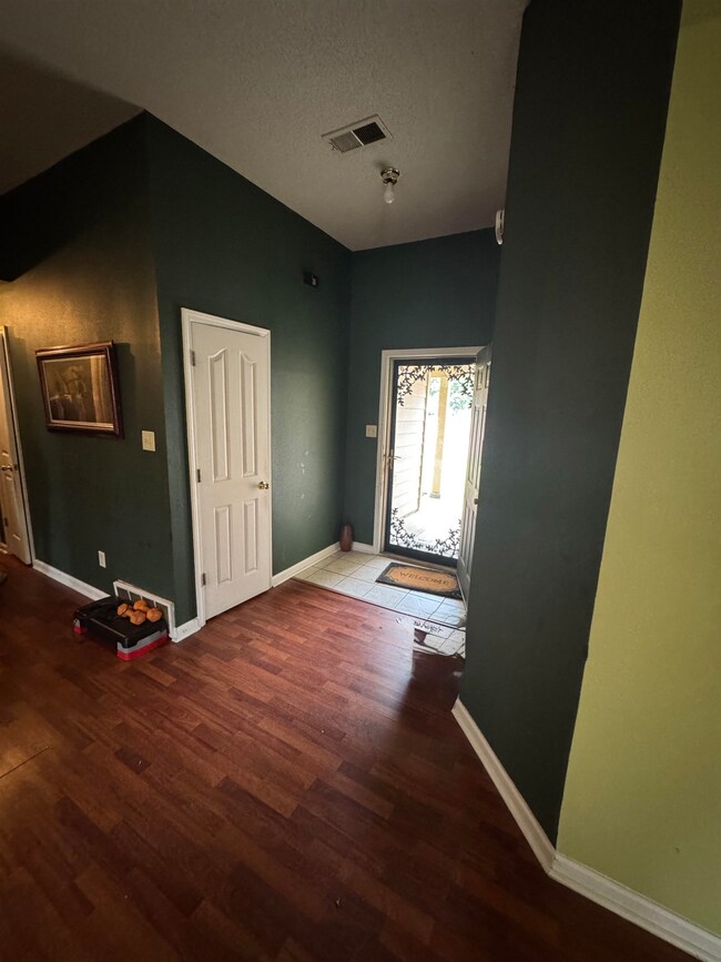 Entrance foyer with wood finished floors, baseboar