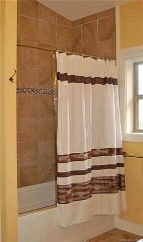Lovely tile work around tub and shower