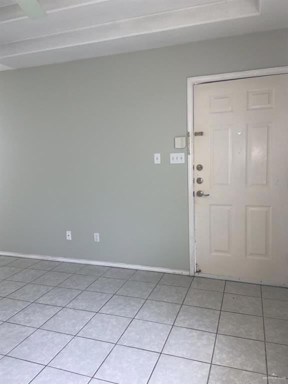 Entryway featuring light tile patterned floors and baseboards