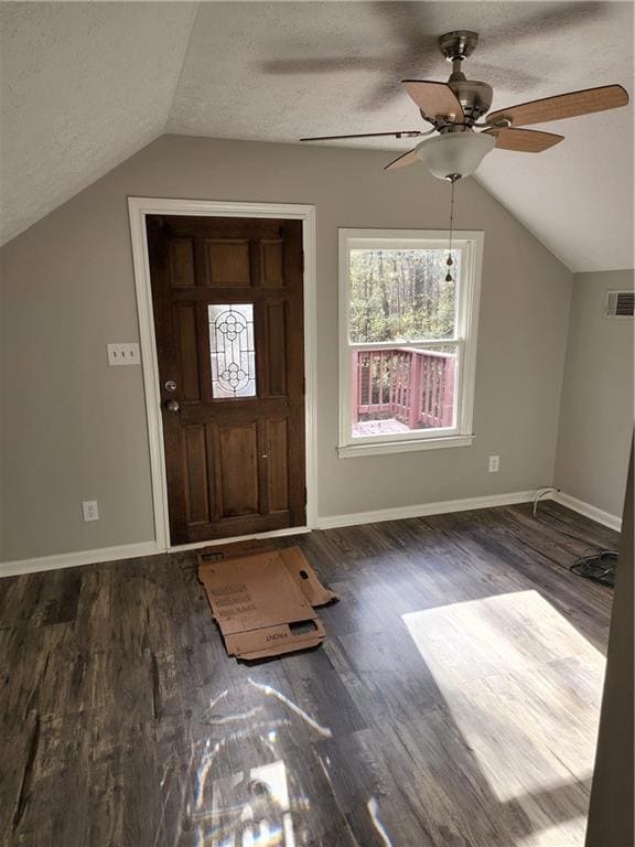 Full bath featuring baseboards, wood finished floors, toilet, and a bathtub