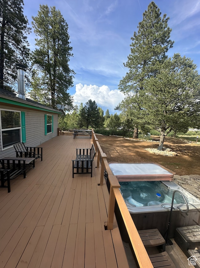 Wooden deck featuring a hot tub