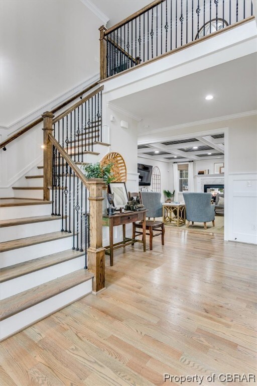 Stairway featuring crown molding, coffered ceiling