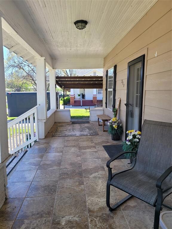 View of patio featuring a porch