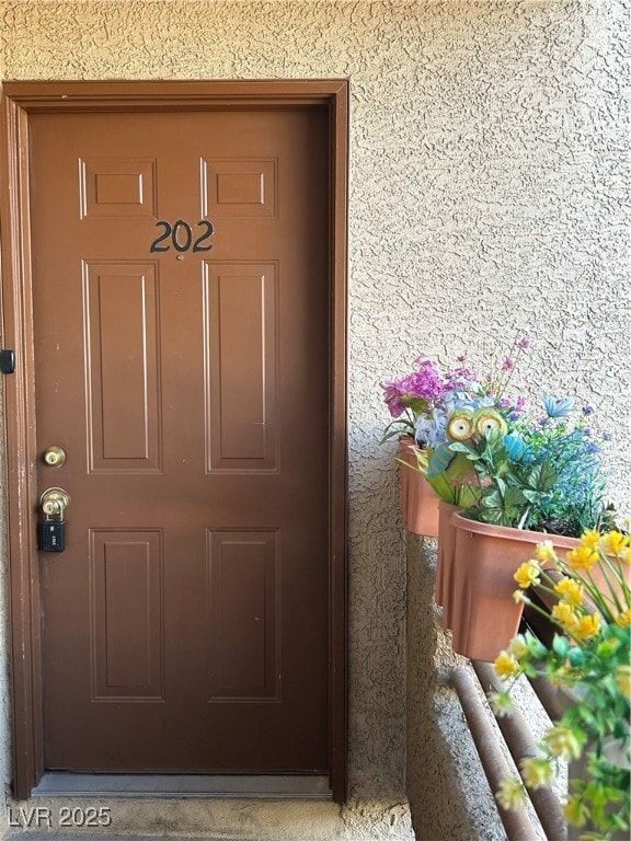 Entrance to property featuring stucco siding