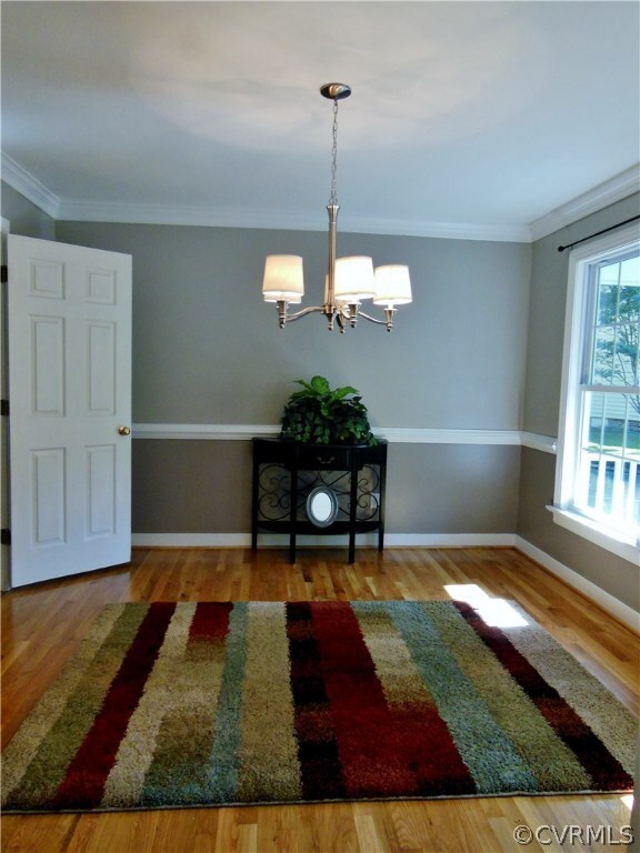 Dining Room- Refinished Hardwoods & Chandelier.