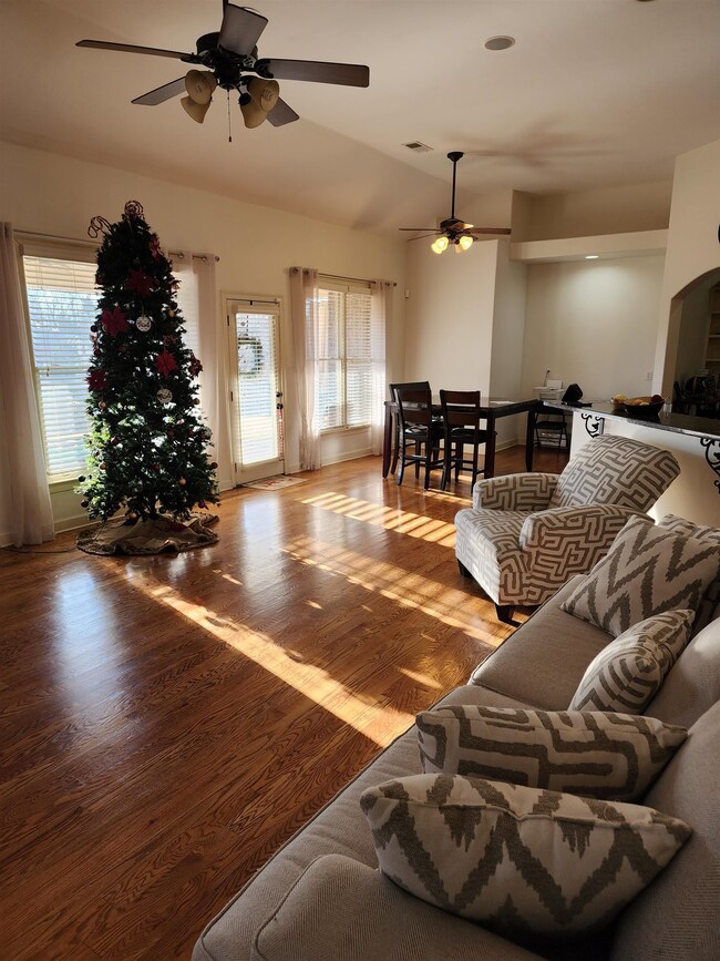 Living room with vaulted ceiling, light hardwood /