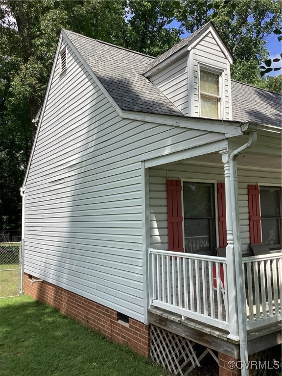 View of side of home featuring crawl space, a shin
