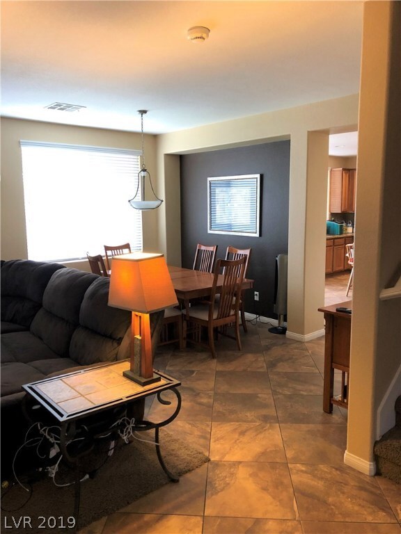 DINING AREA AND KITCHEN TO THE RIGHT.