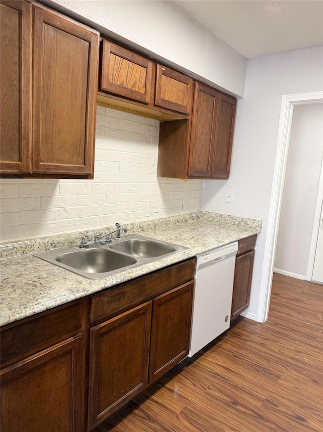 Kitchen with dishwasher, a sink, light countertop