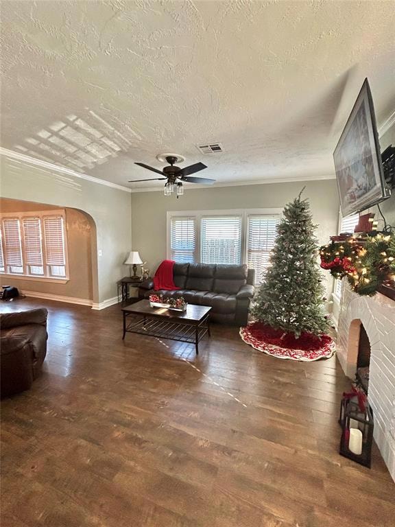 Living room featuring a textured ceiling, crown mo