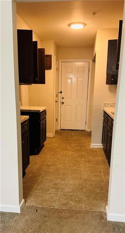 Kitchen featuring dark brown cabinetry