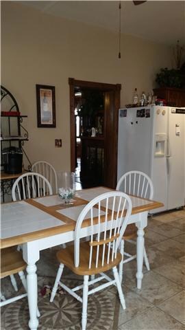 Eat in kitchen is roomy with a view of your huge back deck out of your kitchen window, side door into kitchen from your garage and parking area