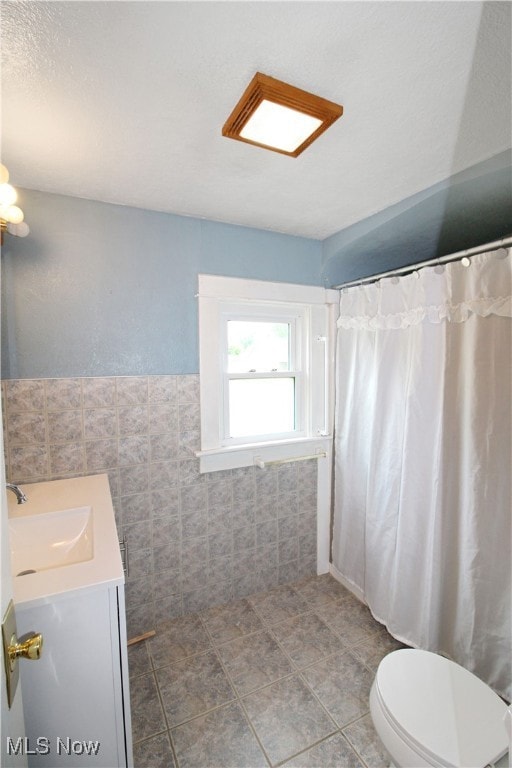 Full bath featuring vanity, toilet, a shower with curtain, and tile patterned floors