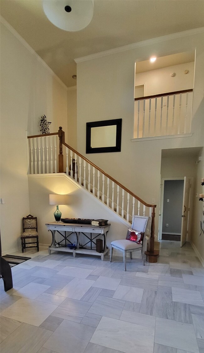 View of entryway and staircase #1 from living room. Door to master bedroom bottom right.