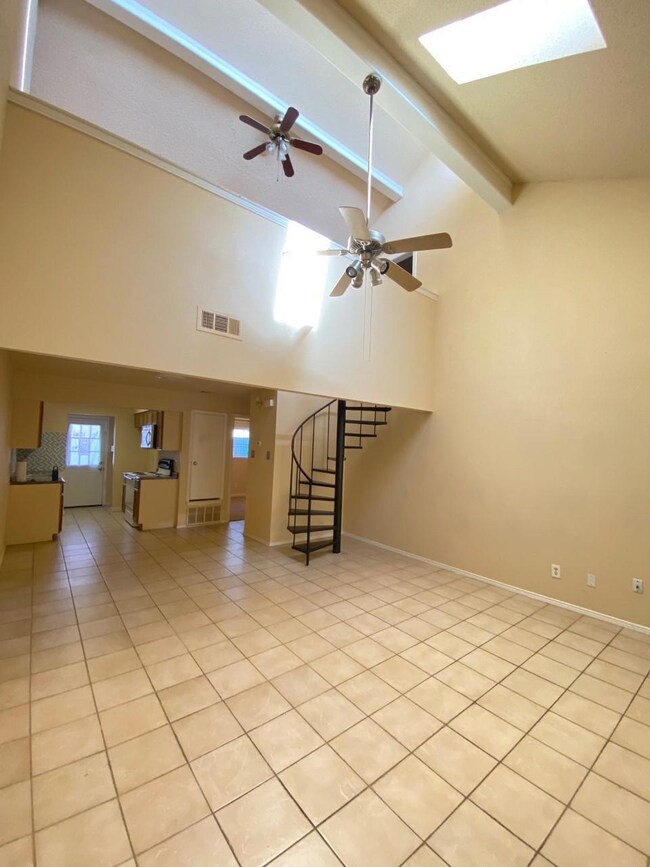 Unfurnished living room featuring light tile patte