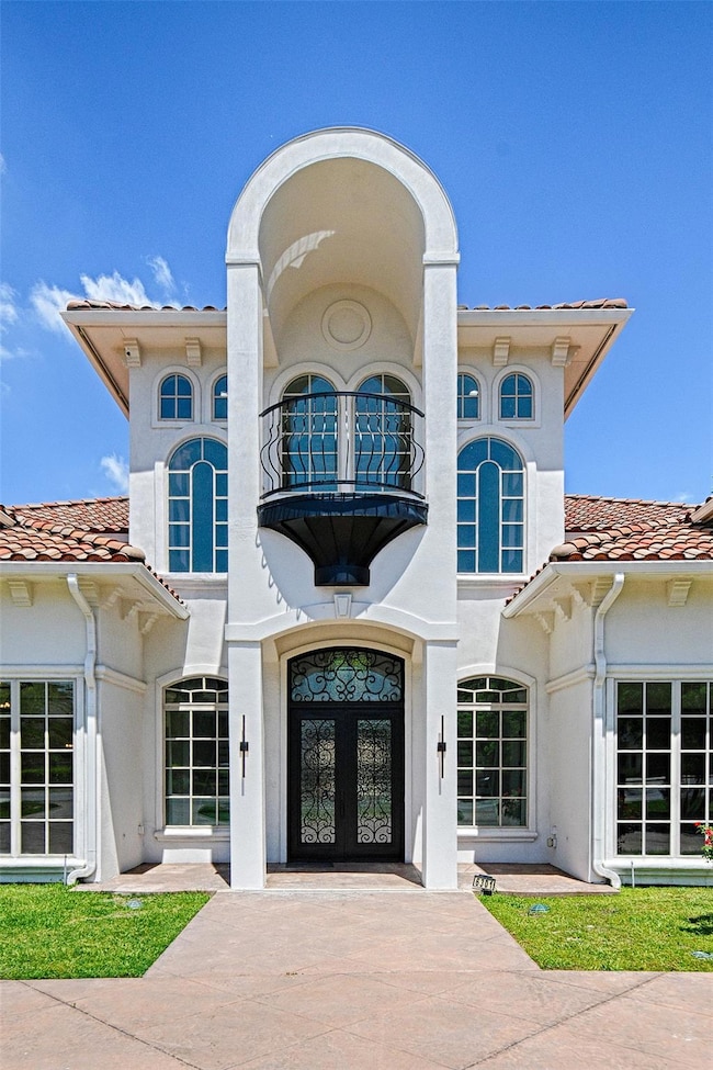 View of front of property featuring a tile roof, f