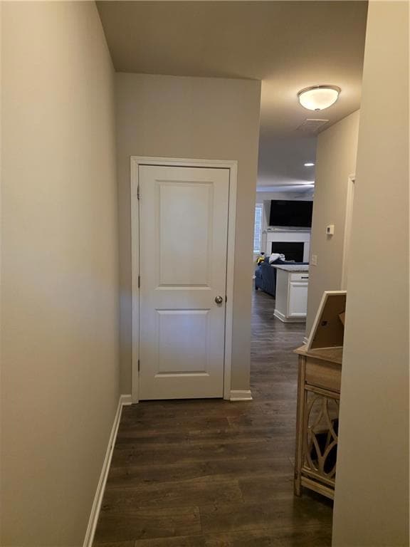 Hallway with dark wood-type flooring