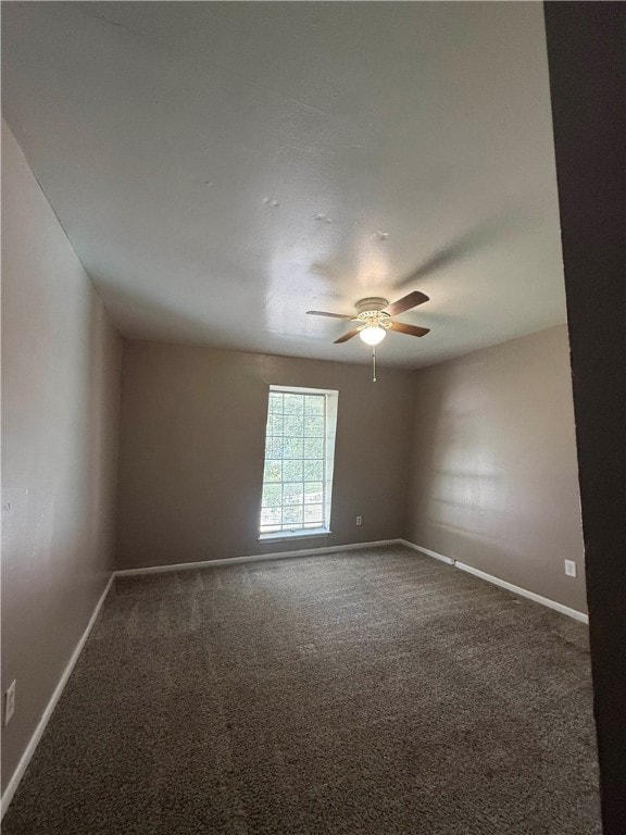 Unfurnished room featuring carpet and a ceiling fa