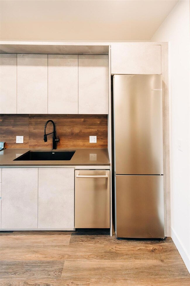 Kitchen with white cabinets, modern cabinets, sta
